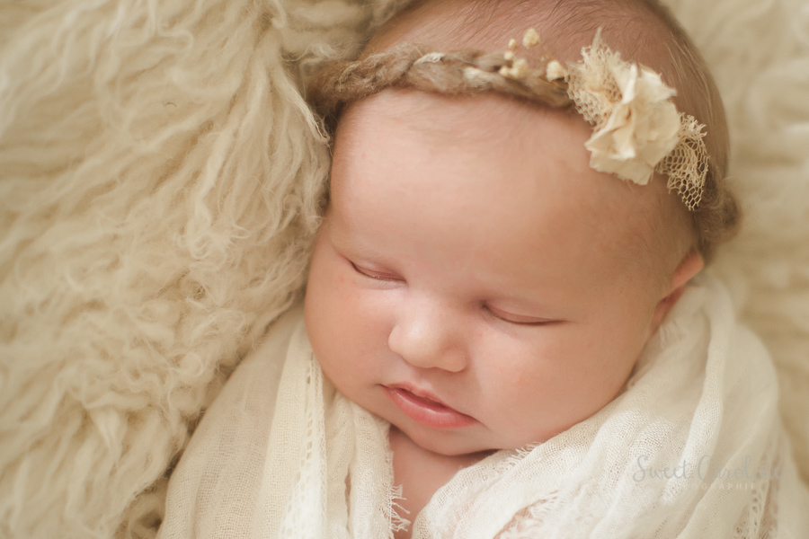 newborn baby girl in organic wrap