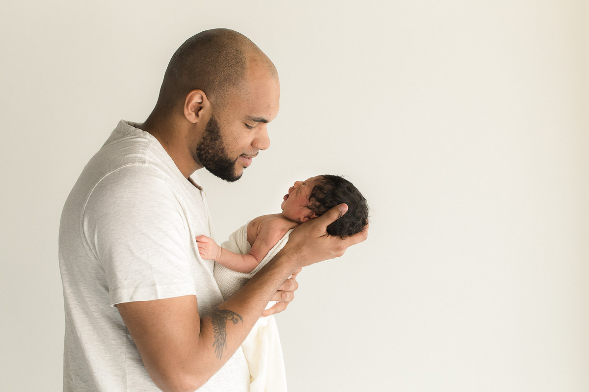 studio newborn in father's arms photograph | Sweet Caroline Photographie