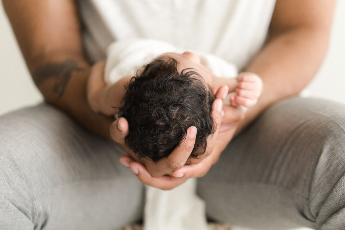studio newborn in father's hands photograph | Sweet Caroline Photographie